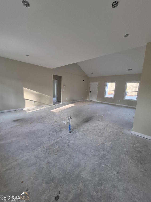 empty room featuring lofted ceiling