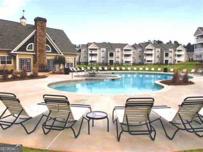 view of swimming pool featuring a patio area