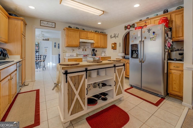 kitchen with stainless steel appliances, tasteful backsplash, sink, and light tile patterned floors