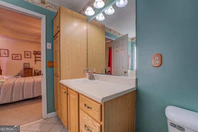 bathroom featuring vanity, toilet, and tile patterned flooring