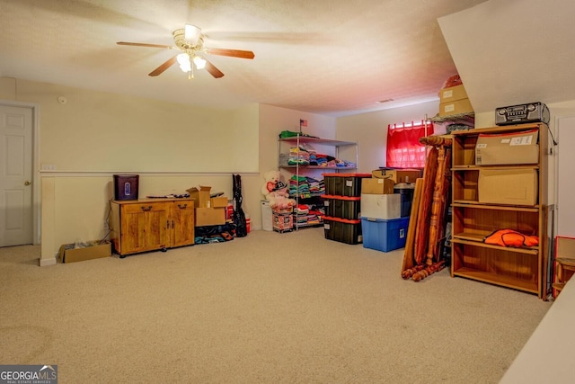 interior space featuring carpet flooring and ceiling fan