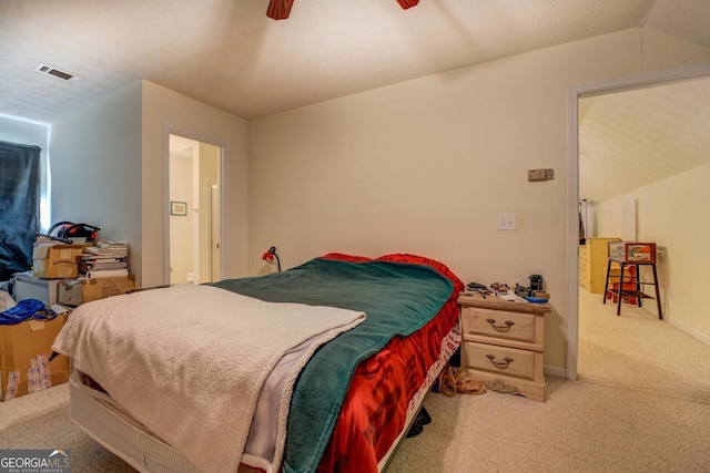 bedroom with light carpet, lofted ceiling, and ceiling fan