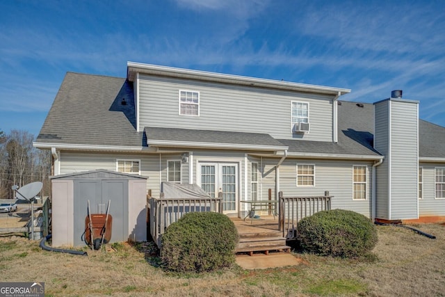 back of house featuring a wooden deck, a yard, cooling unit, and a storage shed