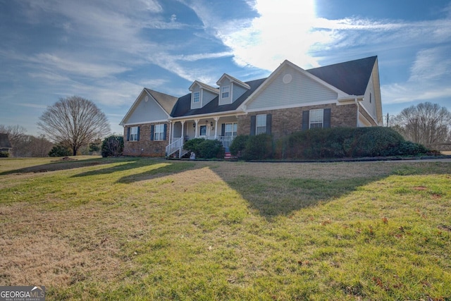 cape cod home featuring a front yard and covered porch