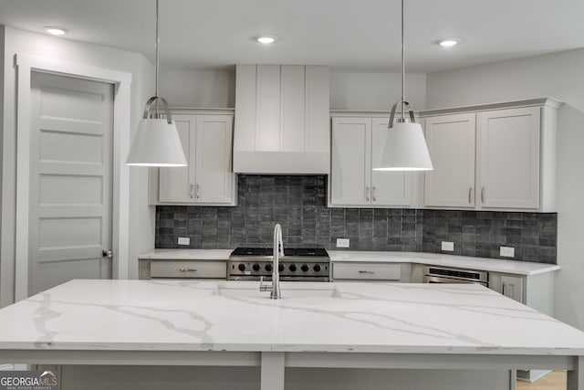 662 Lake Circle Rd, Buchanan, GA 30113 - kitchen with hanging light fixtures, backsplash, light stone counters, and recessed lighting