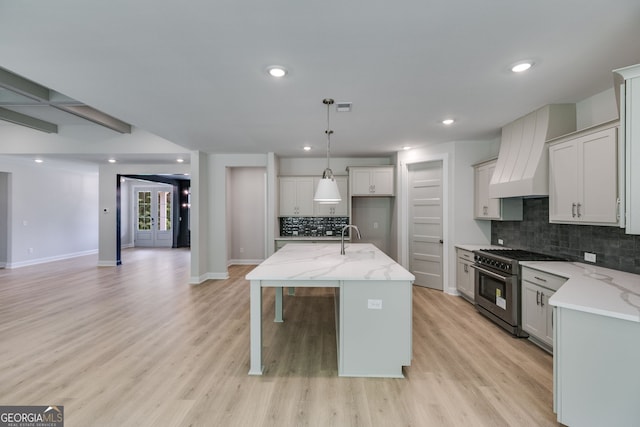 662 Lake Circle Rd, Buchanan, GA 30113 - kitchen featuring high end range, custom exhaust hood, a sink, decorative backsplash, and light stone countertops