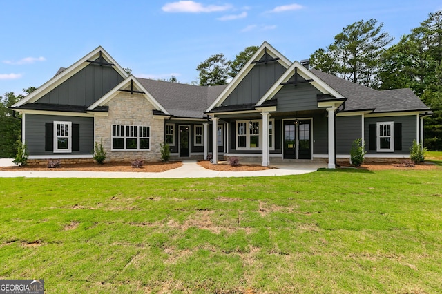 662 Lake Circle Rd, Buchanan, GA 30113 - rear view of property featuring board and batten siding, a yard, stone siding, and a shingled roof