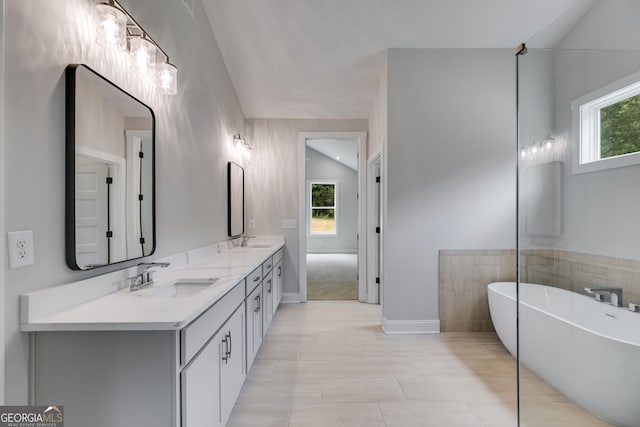 662 Lake Circle Rd, Buchanan, GA 30113 - bathroom with a freestanding tub, plenty of natural light, double vanity, and baseboards