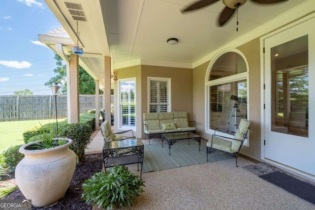 view of patio with an outdoor living space and ceiling fan