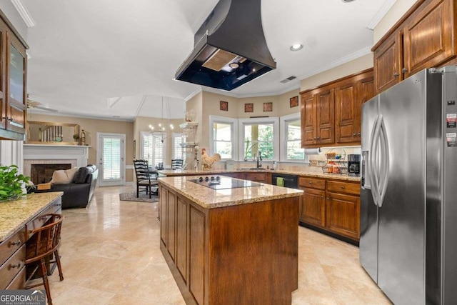 kitchen with light stone counters, island range hood, a kitchen island, and black appliances