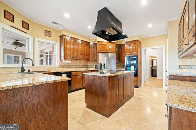 kitchen featuring sink, island exhaust hood, light stone counters, black appliances, and a kitchen island