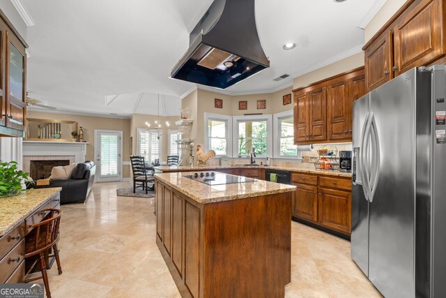 kitchen with light stone counters, a kitchen island, range hood, decorative backsplash, and black appliances