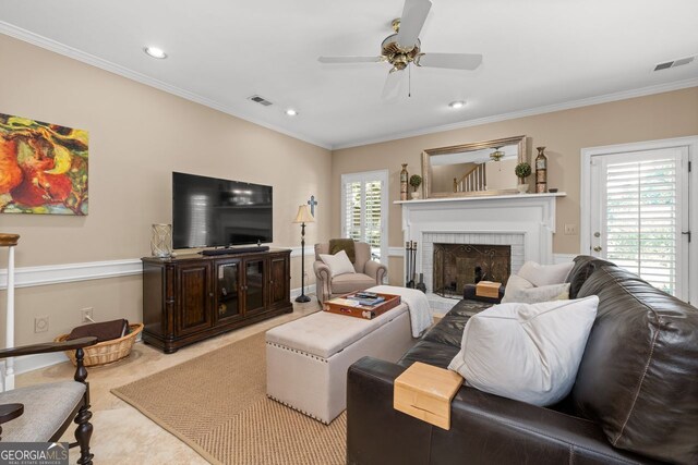 living room with crown molding and ceiling fan