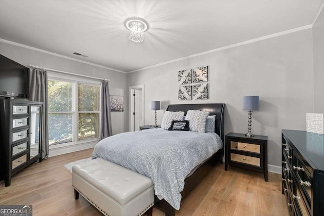 bedroom with hardwood / wood-style floors and ornamental molding