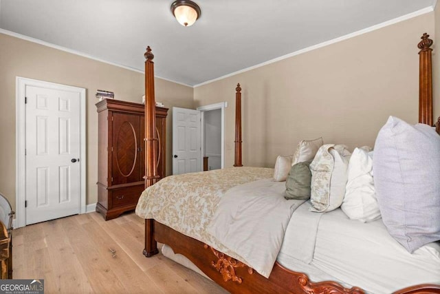 bedroom with ornamental molding and light wood-type flooring