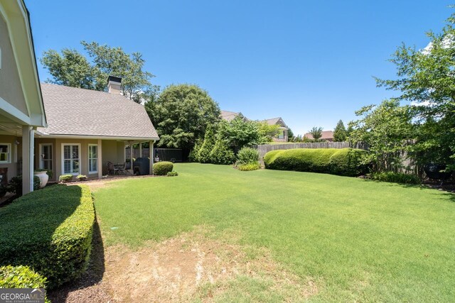 back of house with a yard