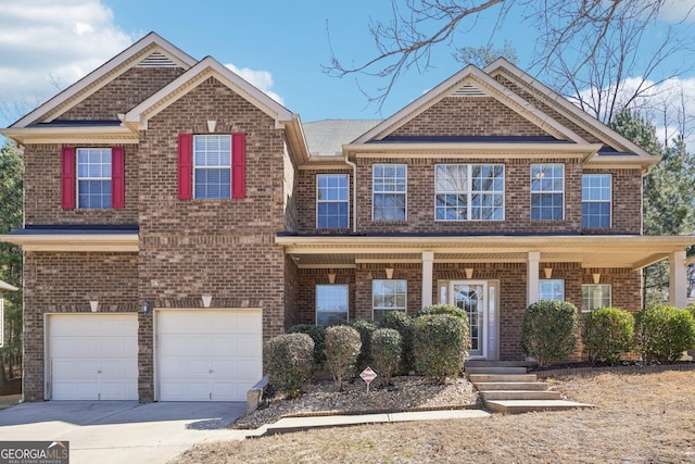 view of front of property featuring a garage, driveway, a porch, and brick siding