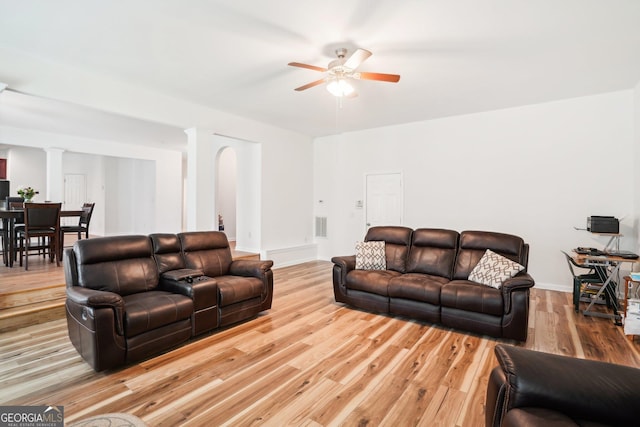 248 Allegrini Dr, Atlanta, GA 30349 - living room with ceiling fan, wood finished floors, visible vents, baseboards, and decorative columns