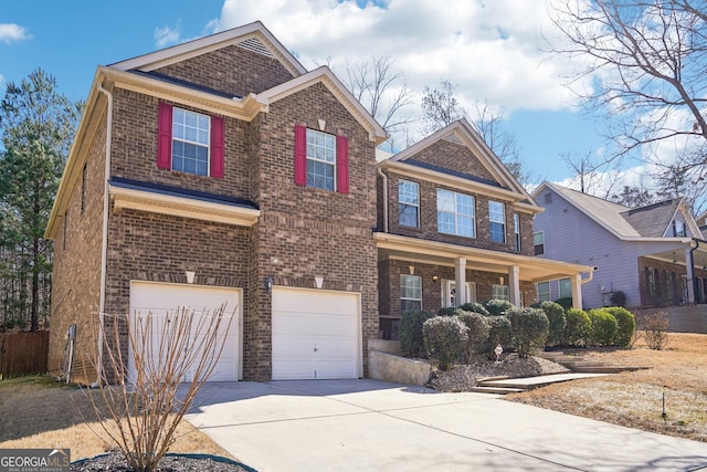 view of front of house with an attached garage, concrete driveway, and brick siding