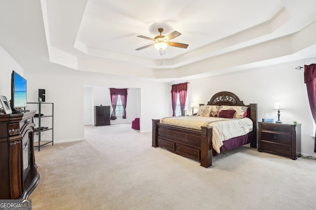 248 Allegrini Dr, Atlanta, GA 30349 - bedroom featuring baseboards, ceiling fan, a tray ceiling, and light colored carpet