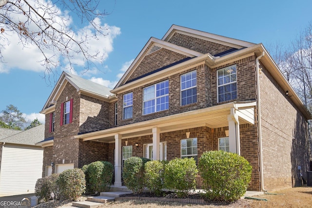 view of front of property with a porch and brick siding