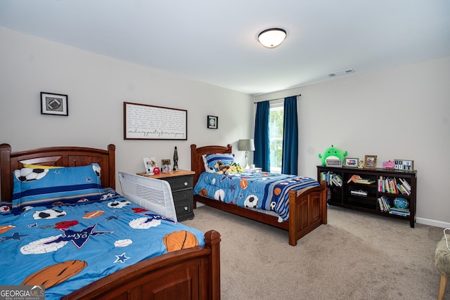 bedroom featuring light carpet and visible vents