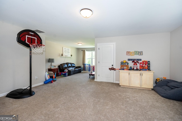 playroom with baseboards, visible vents, and light colored carpet