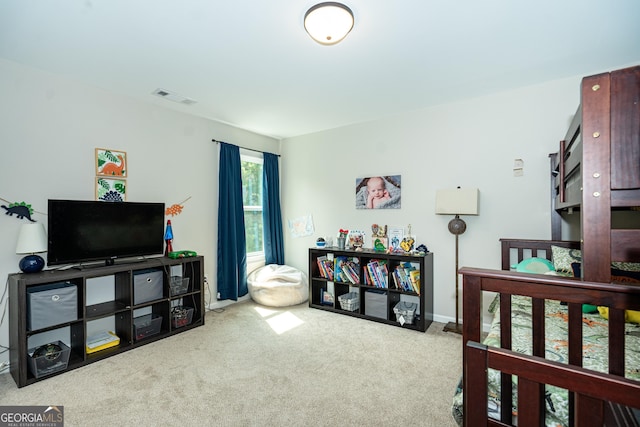 bedroom featuring light colored carpet and visible vents