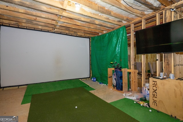 interior space with golf simulator and concrete flooring