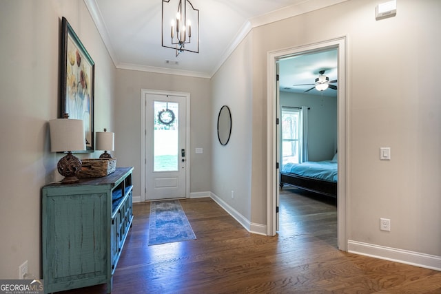 foyer featuring ornamental molding, dark wood-style flooring, a healthy amount of sunlight, and baseboards