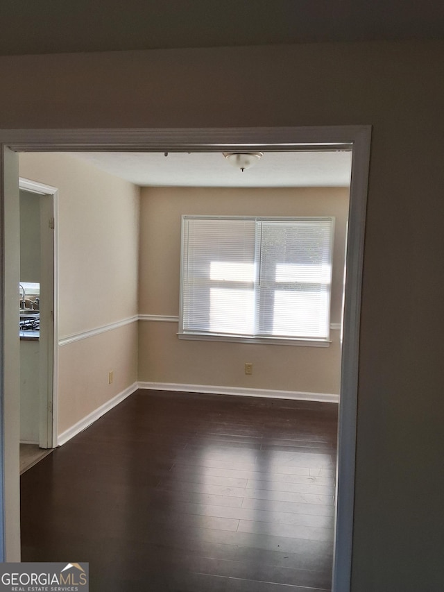 unfurnished room featuring dark hardwood / wood-style floors