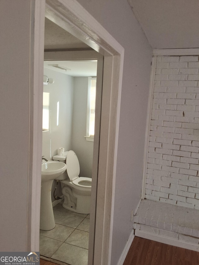 bathroom featuring toilet and hardwood / wood-style floors