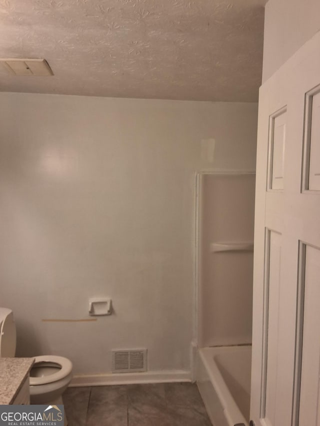 full bathroom featuring vanity, separate shower and tub, toilet, tile patterned floors, and a textured ceiling