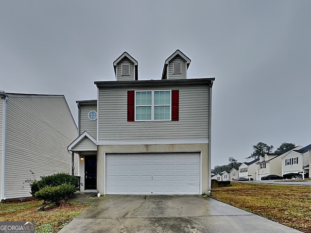 view of front of home featuring a garage and a front yard