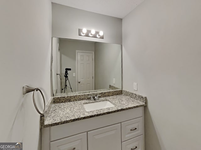 bathroom with vanity and a textured ceiling