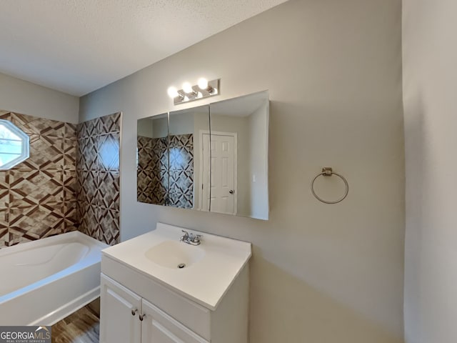 bathroom featuring vanity, hardwood / wood-style floors, and a textured ceiling