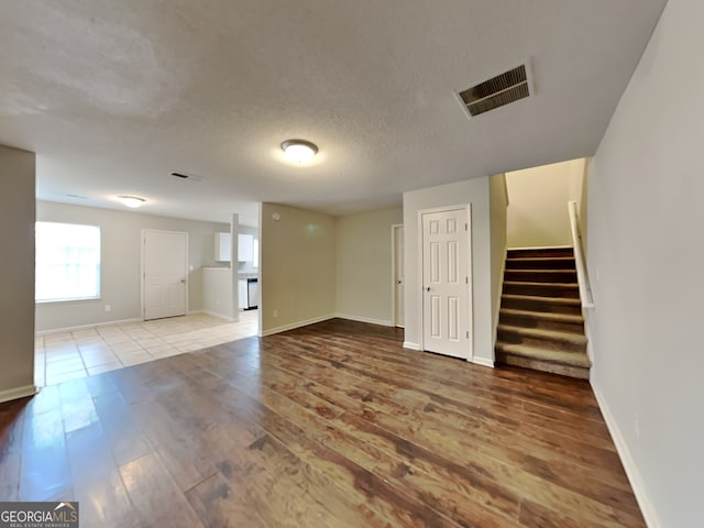 interior space with light hardwood / wood-style flooring and a textured ceiling