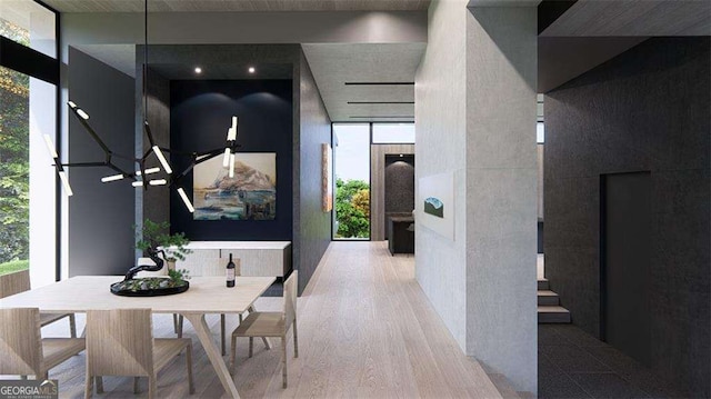 hallway with expansive windows, light hardwood / wood-style flooring, and a wealth of natural light