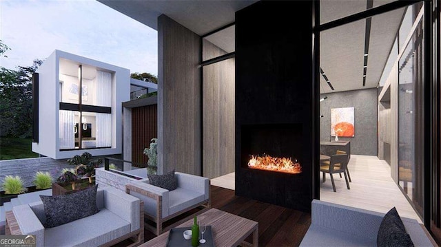 view of patio with an outdoor living space with a fireplace and a deck