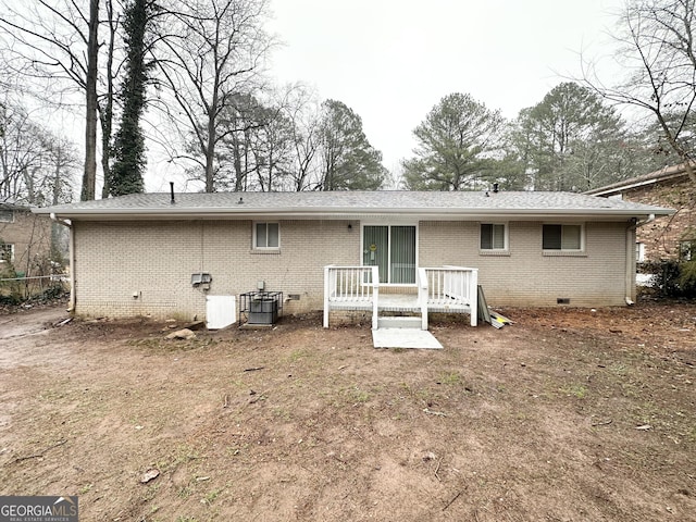 rear view of property featuring central AC unit