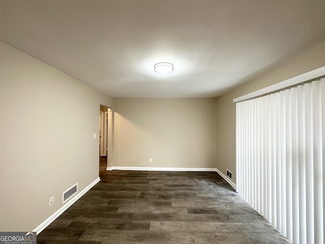 unfurnished room featuring dark hardwood / wood-style floors