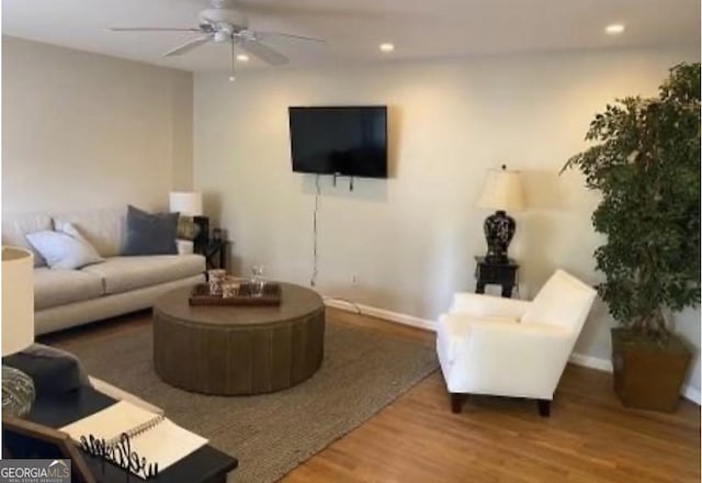 living room with ceiling fan and hardwood / wood-style floors