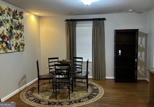 dining space featuring dark hardwood / wood-style floors