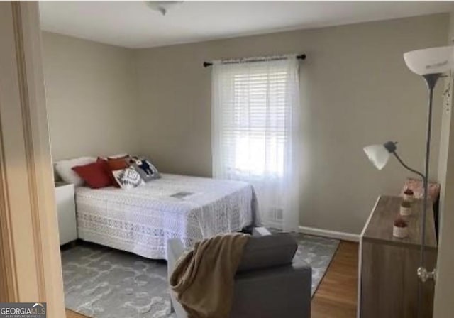 bedroom with dark hardwood / wood-style floors