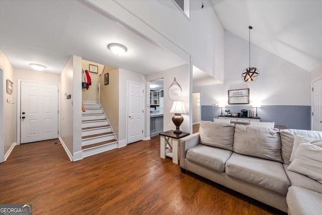 living room featuring dark hardwood / wood-style floors and high vaulted ceiling