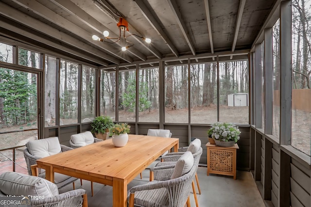 sunroom featuring an inviting chandelier