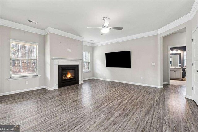 unfurnished living room with ceiling fan, plenty of natural light, and dark hardwood / wood-style flooring