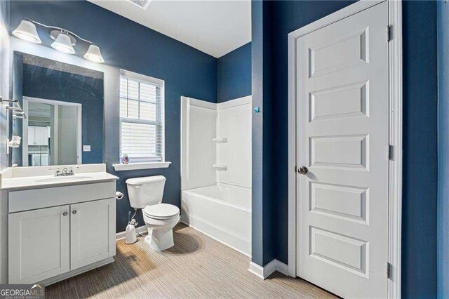 full bathroom with vanity, shower / bathtub combination, and toilet