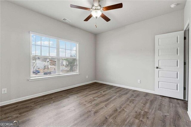 empty room with hardwood / wood-style flooring and ceiling fan