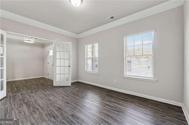 spare room featuring dark wood-type flooring, ornamental molding, and french doors